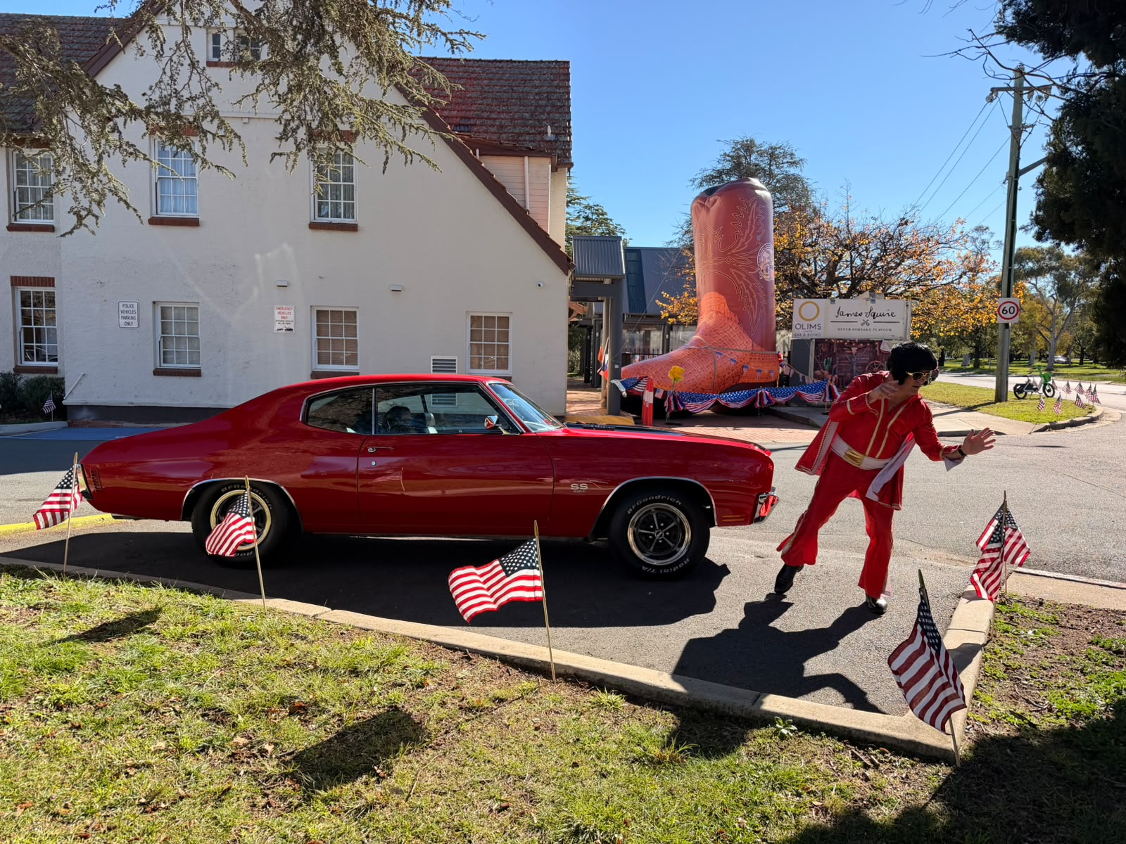Cherry-red Chevelle parked outside Mercure Canberra with Elvis for Fourth of July celebrations